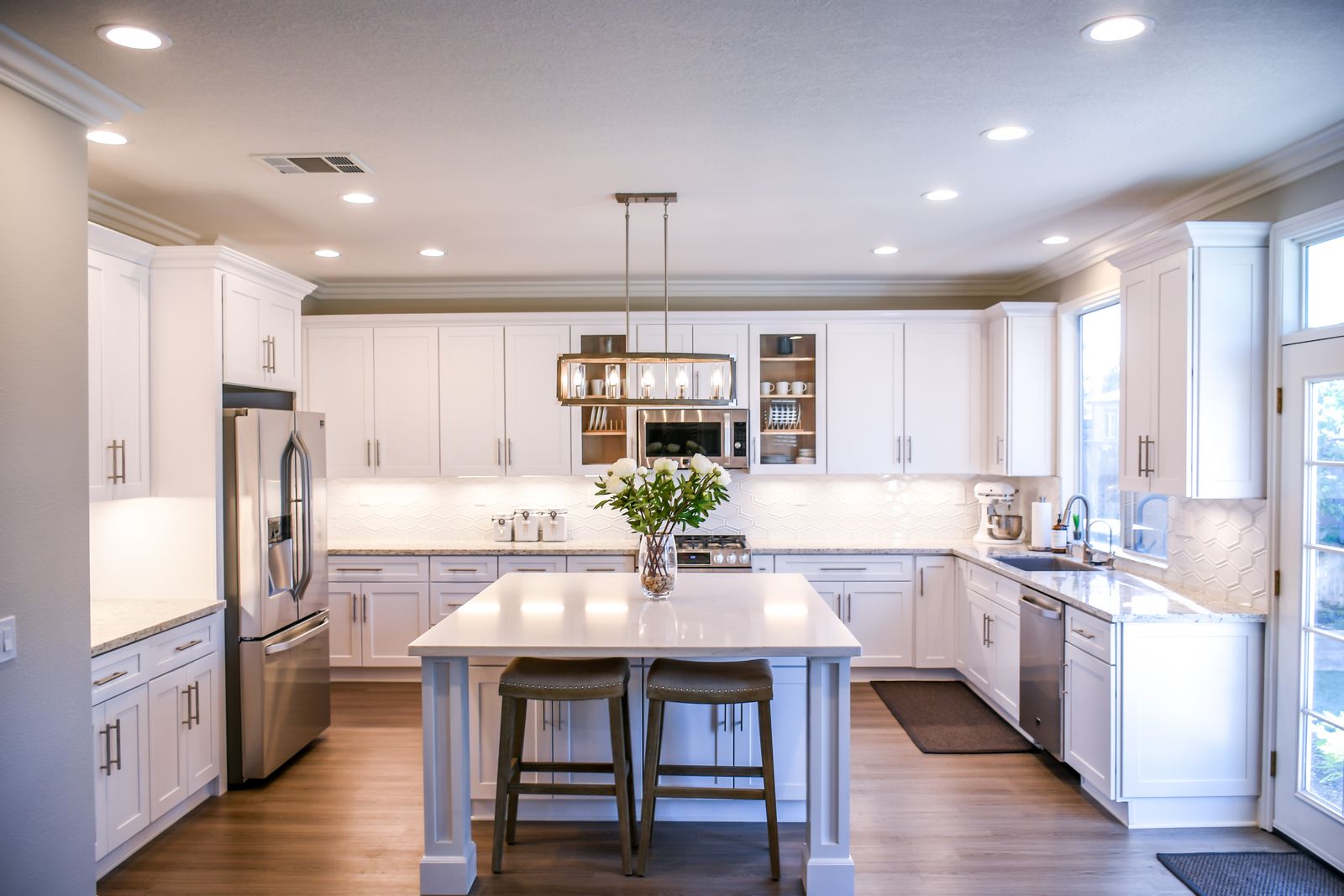 A bright, modern kitchen with a central island, white cabinetry and warm wood floors, the kind of durable, configurable product Circular One is built around.
